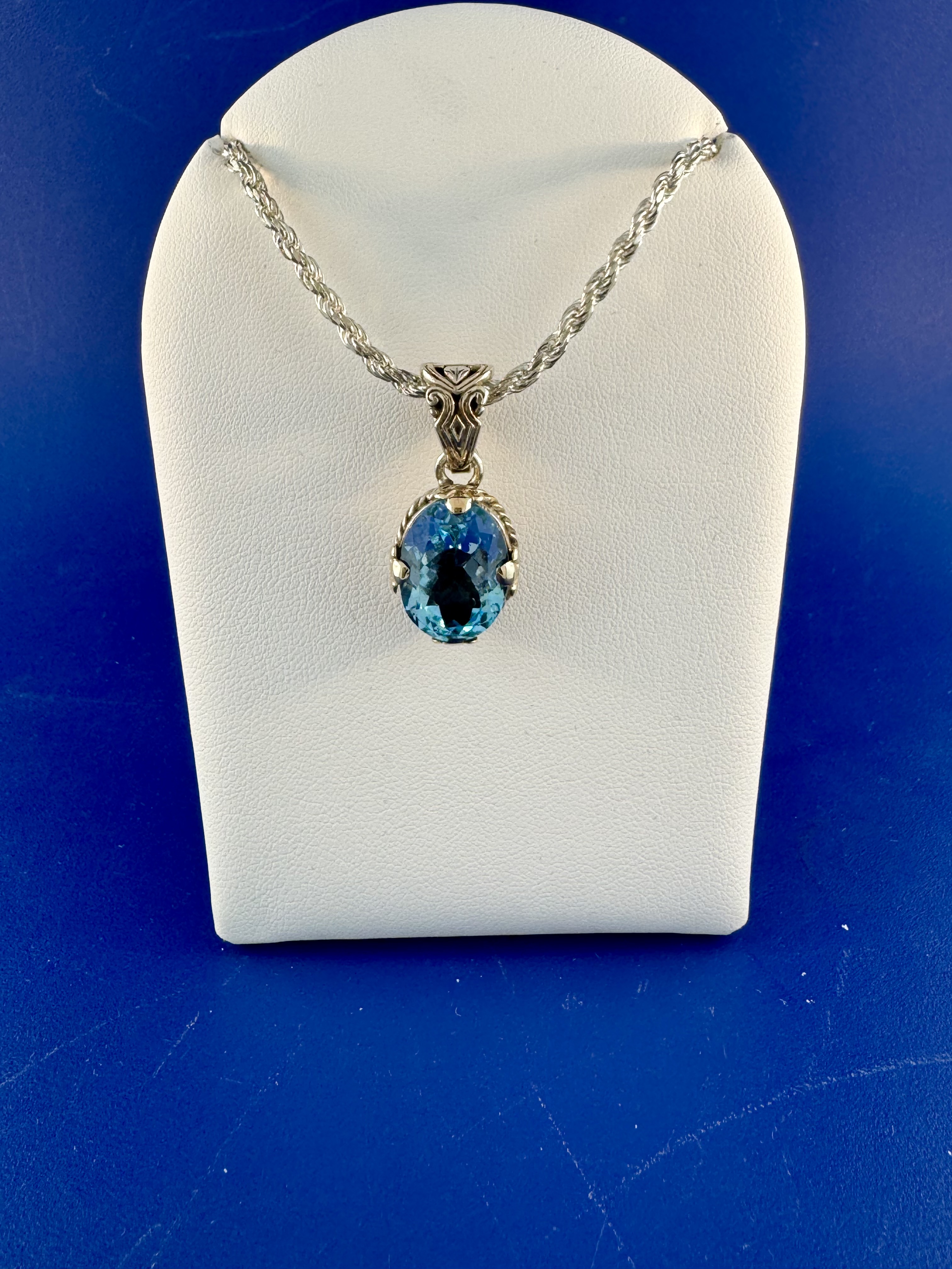 Sterling silver and 18 kt blue topaz pendant