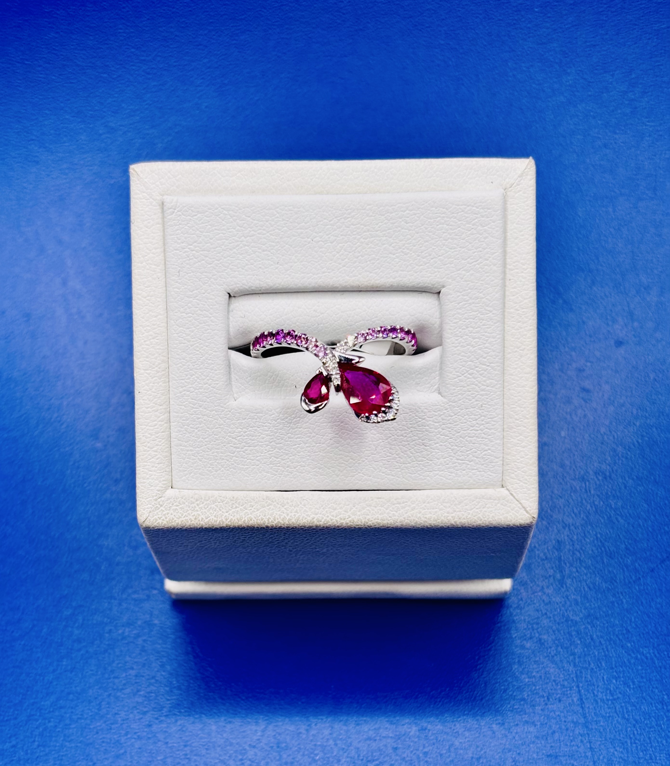 18kt White Gold Ombré Pear Shaped Ruby, Sapphire, & Diamond Band